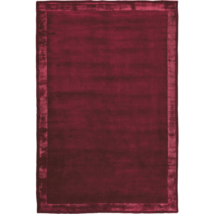 RUGKARI Claret solid pure New Zealand wool luxury rug styled in an Indian living room - image 1